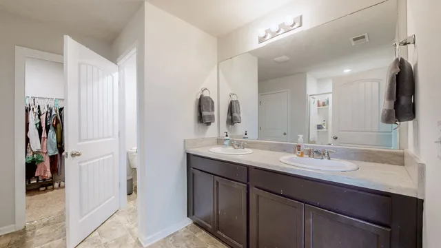 a bathroom with a double vanity sink and a mirror