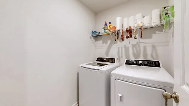 a view of storage and utility room with washer and dryer