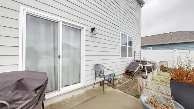 a view of a patio with table and chairs and potted plants
