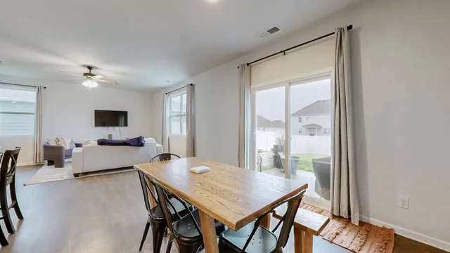a dining room with furniture and window
