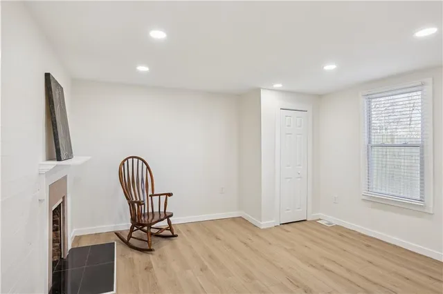 a view of a hallway with wooden floor and windows