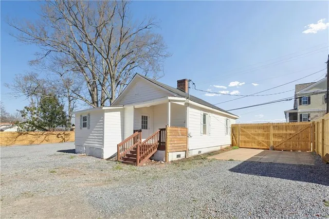 a view of large house with a yard and large trees