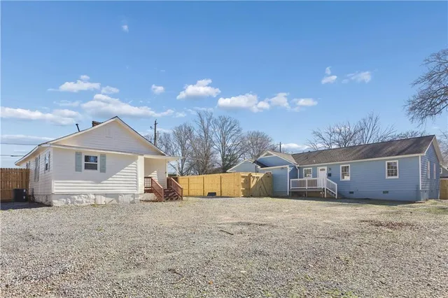 a view of white house with a yard