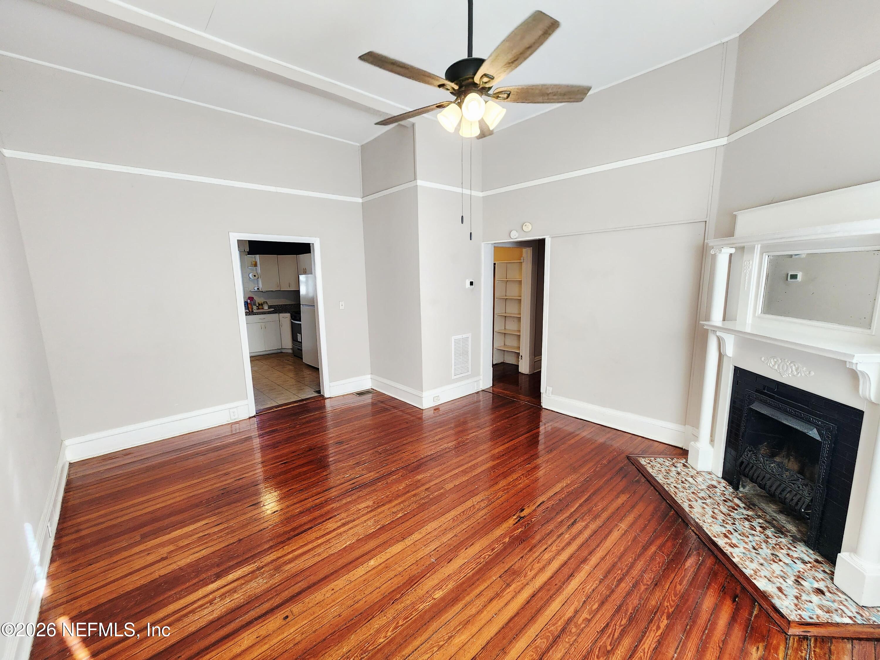 1719 Aberdeen Street Jacksonville, FL 32205 - Photo 4 of 17 a view of an empty room with wooden floor fireplace and a window