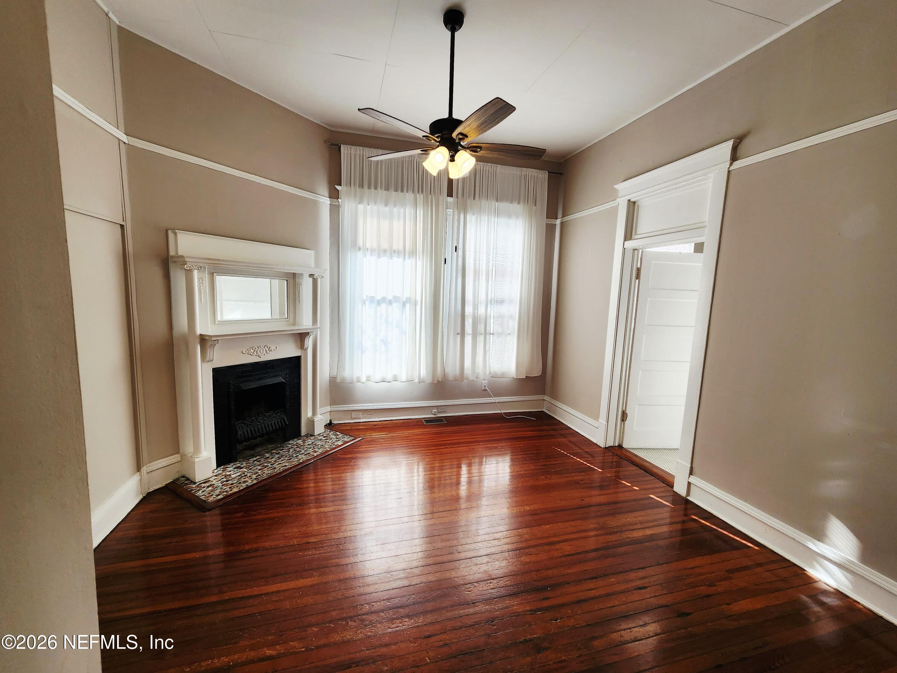 1719 Aberdeen Street Jacksonville, FL 32205 - Photo 5 of 17 a view of an empty room with wooden floor fireplace and a window