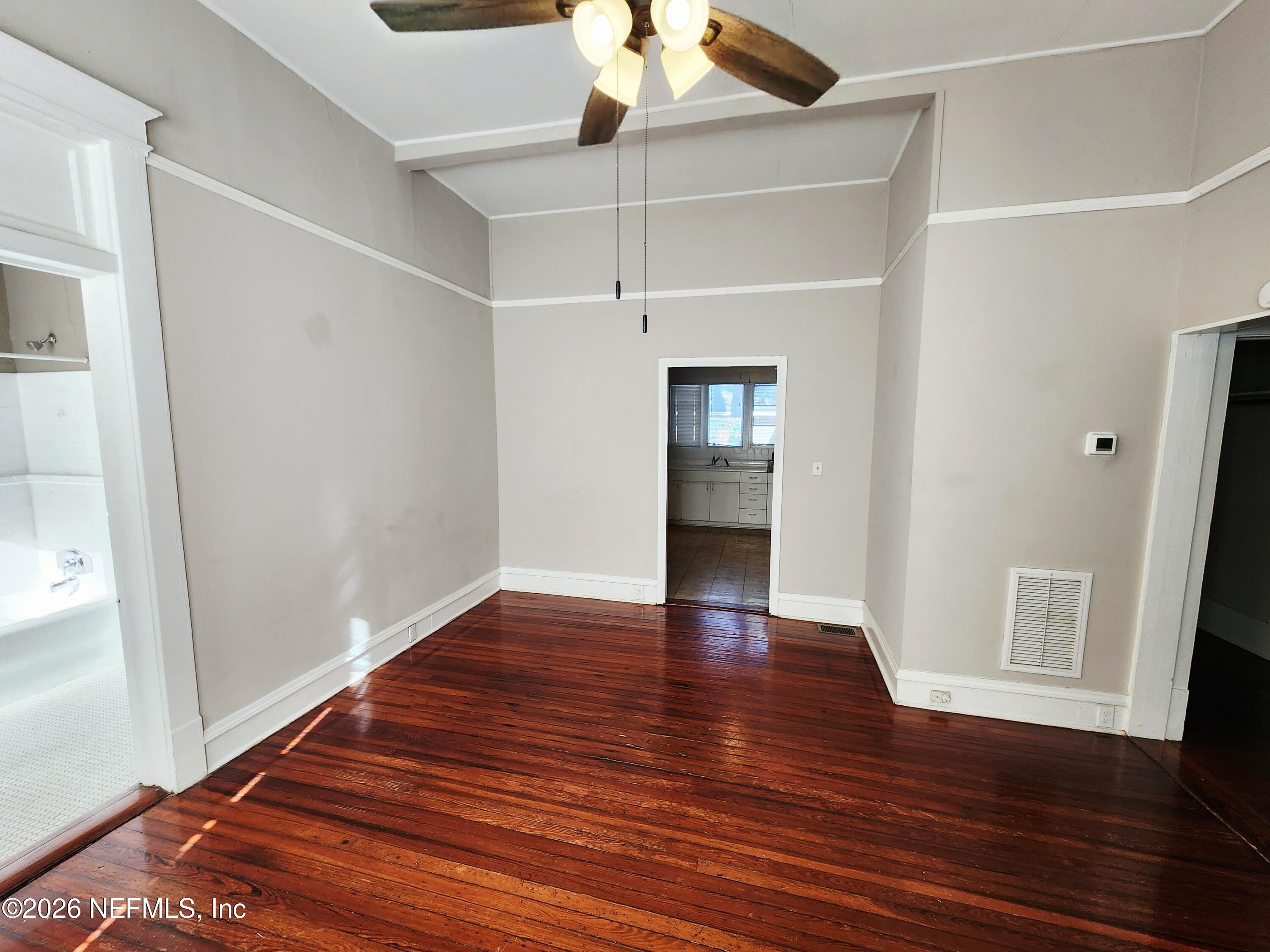 1719 Aberdeen Street Jacksonville, FL 32205 - Photo 6 of 17 a view of an empty room with wooden floor and a window