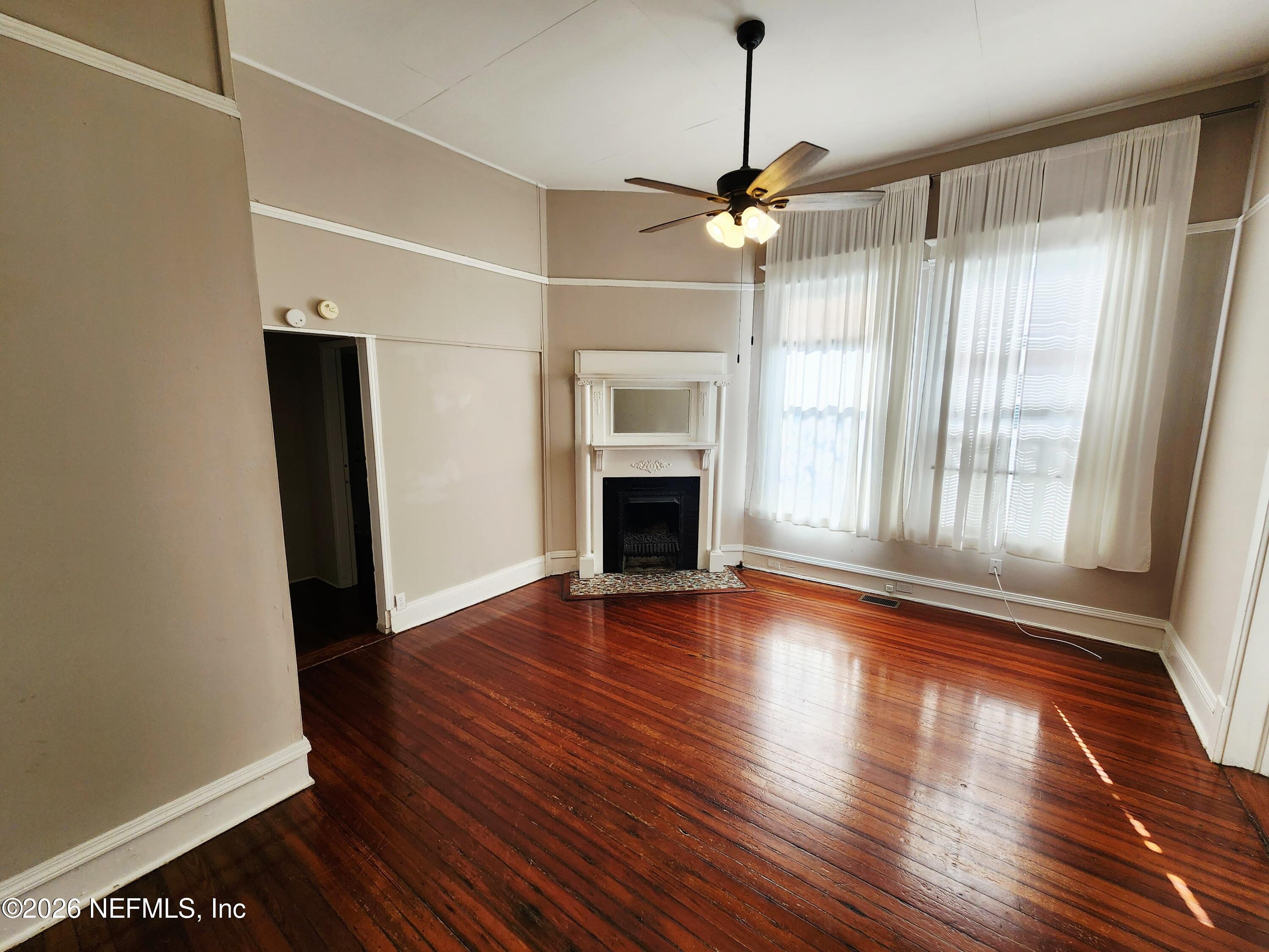 1719 Aberdeen Street Jacksonville, FL 32205 - Photo 7 of 17 a view of empty room with wooden floor and fireplace