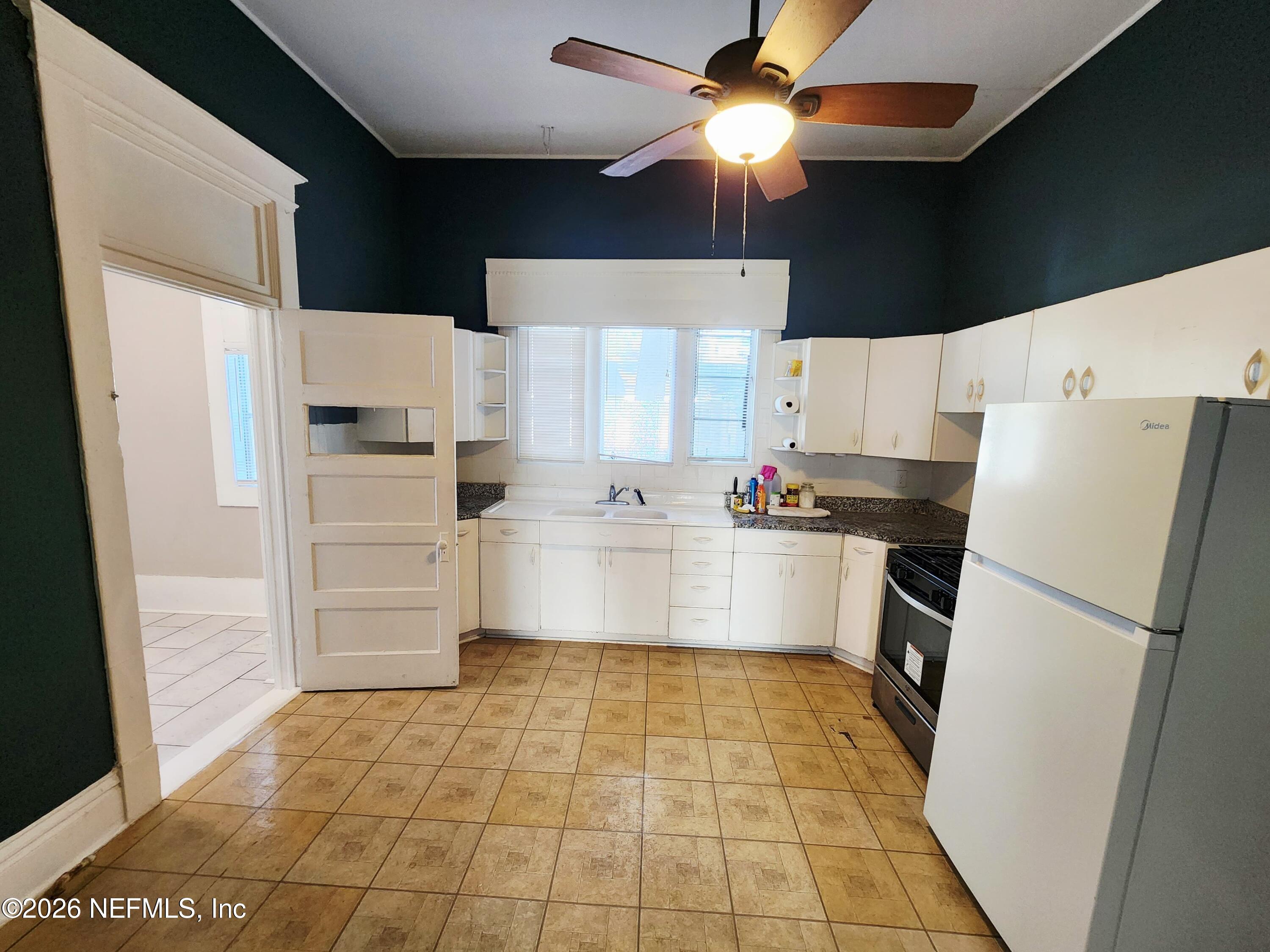 1719 Aberdeen Street Jacksonville, FL 32205 - Photo 8 of 17 a kitchen with stainless steel appliances a refrigerator sink and cabinets