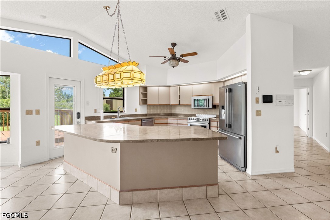 27255 Hickory Hill Road Brooksville, FL 34602 - Photo 22 of 50 a kitchen with stainless steel appliances granite countertop a sink a counter top space cabinets and a window