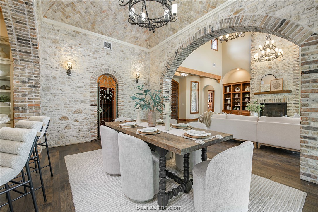 4207 Tuscany Court Bryan, TX 77802 - Photo 15 of 46 a dining room with wooden floor a chandelier a wooden table and chairs