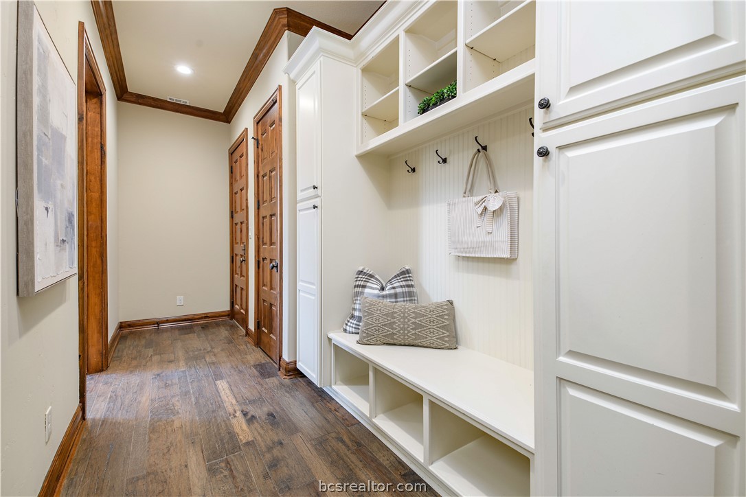 4207 Tuscany Court Bryan, TX 77802 - Photo 21 of 46 a hallway with white cabinets and wooden floor