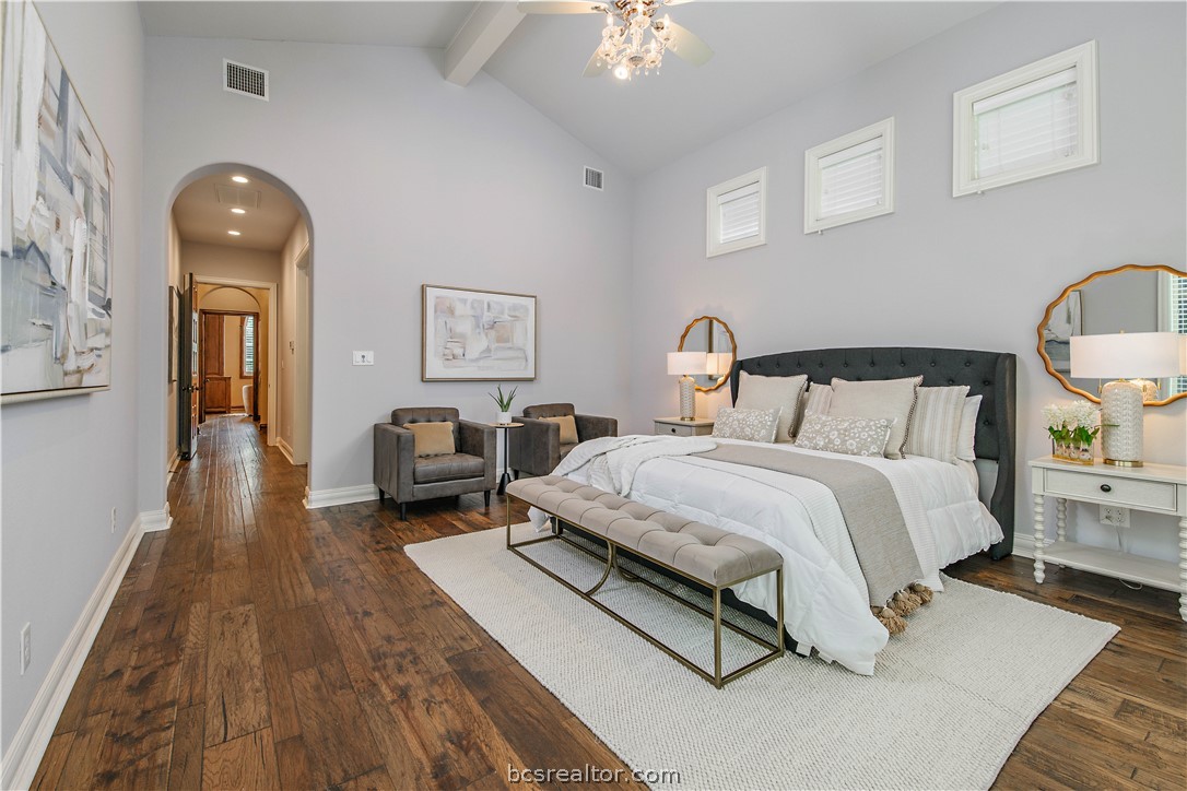 4207 Tuscany Court Bryan, TX 77802 - Photo 26 of 46 a spacious bedroom with a bed and wooden floor