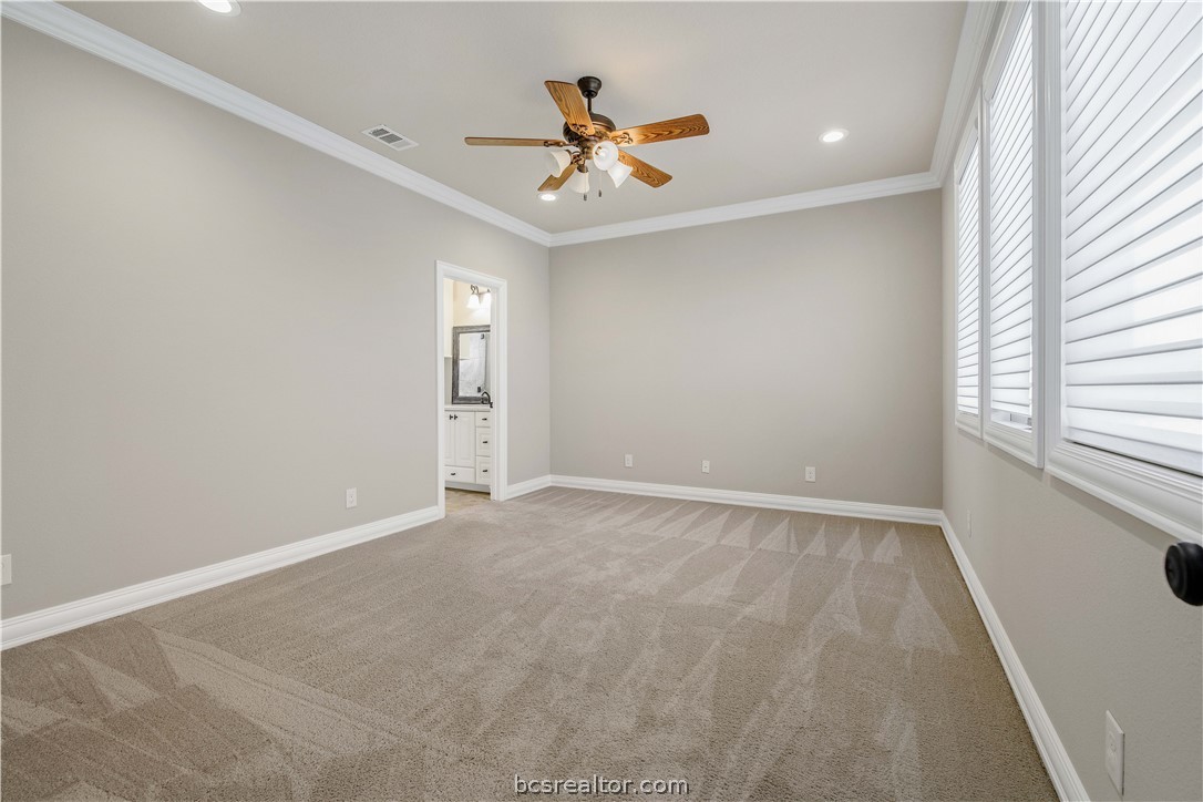 4207 Tuscany Court Bryan, TX 77802 - Photo 36 of 46 an empty room with window and ceiling fan
