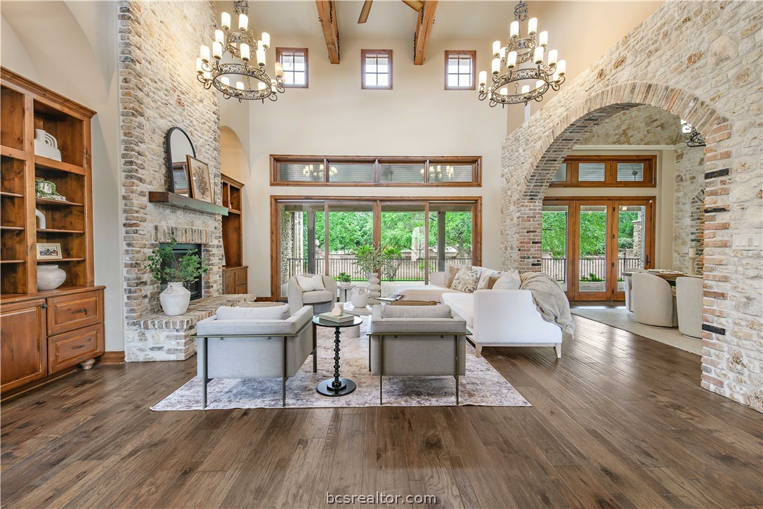 4207 Tuscany Court Bryan, TX 77802 - Photo 6 of 46 a living room with fireplace furniture and a chandelier
