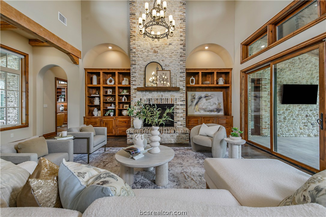 4207 Tuscany Court Bryan, TX 77802 - Photo 9 of 46 a living room with fireplace furniture and a large window