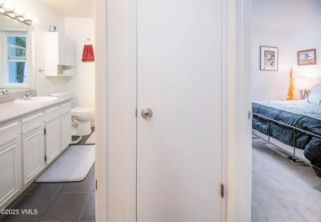 a bedroom with a bed chair and window