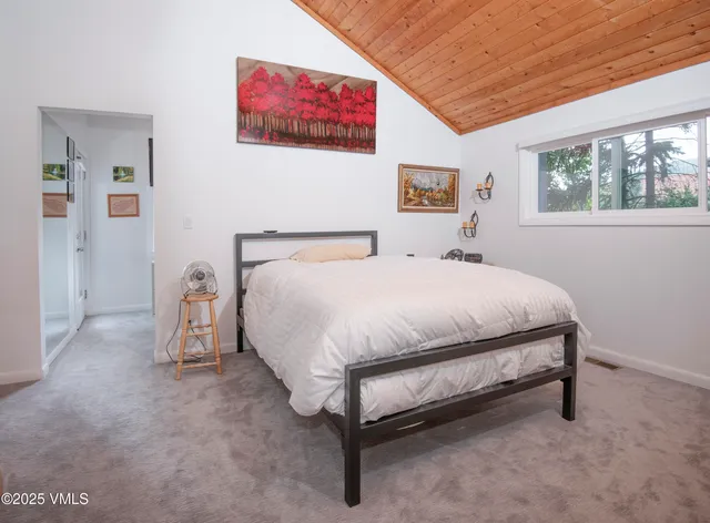 a spacious bedroom with a bed and a couch