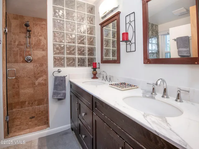 a work room with furniture a flat screen tv and a window