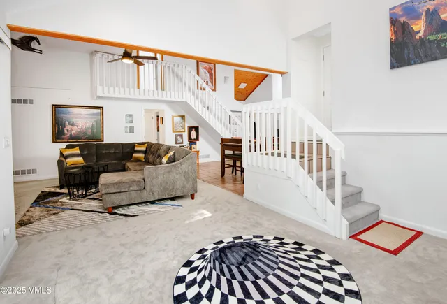 a living room with furniture a window and a flat screen tv