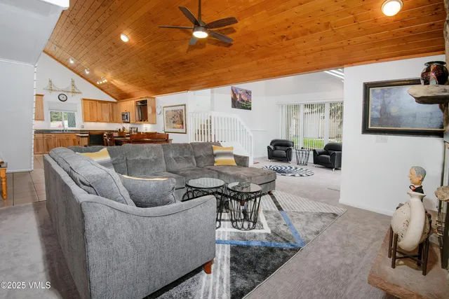 a living room with furniture a flat screen tv and a table