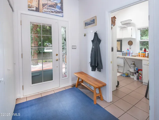 a patio with glass top table and chairs