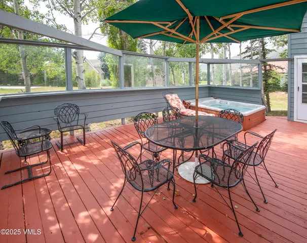 a view of a patio with table and chairs potted plants and large tree