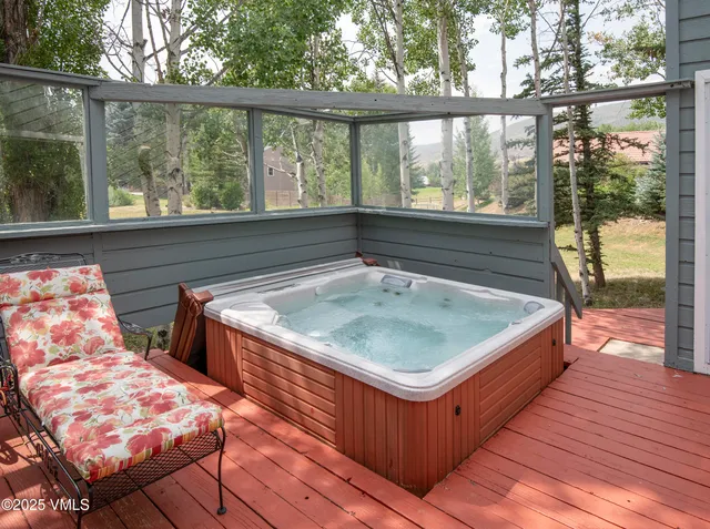 a front view of a house with a yard and potted plants