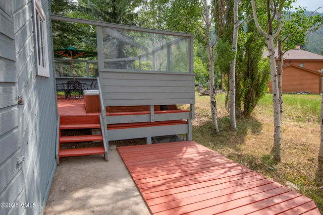 a backyard of a house with plants and trees