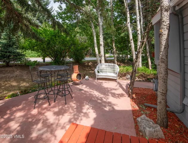an aerial view of a house with a garden and lake view