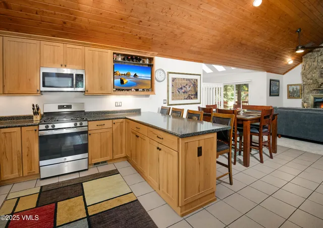a kitchen with stainless steel appliances granite countertop a stove a sink dishwasher and a refrigerator