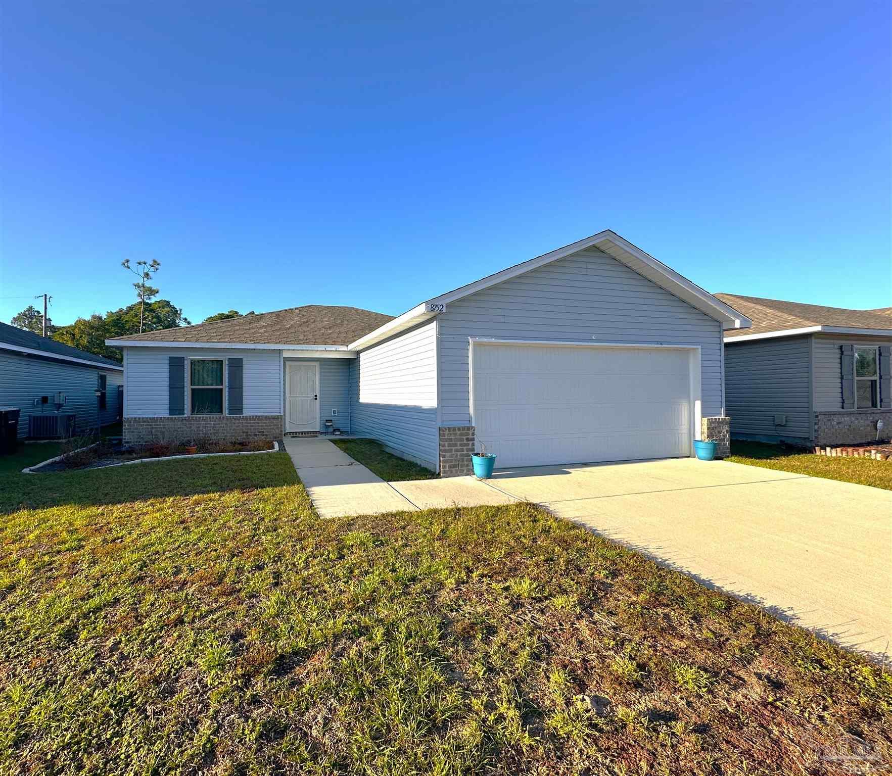 8752 Schooner Lane Pensacola, FL 32507 - Photo 1 of 13 a front view of a house with a yard