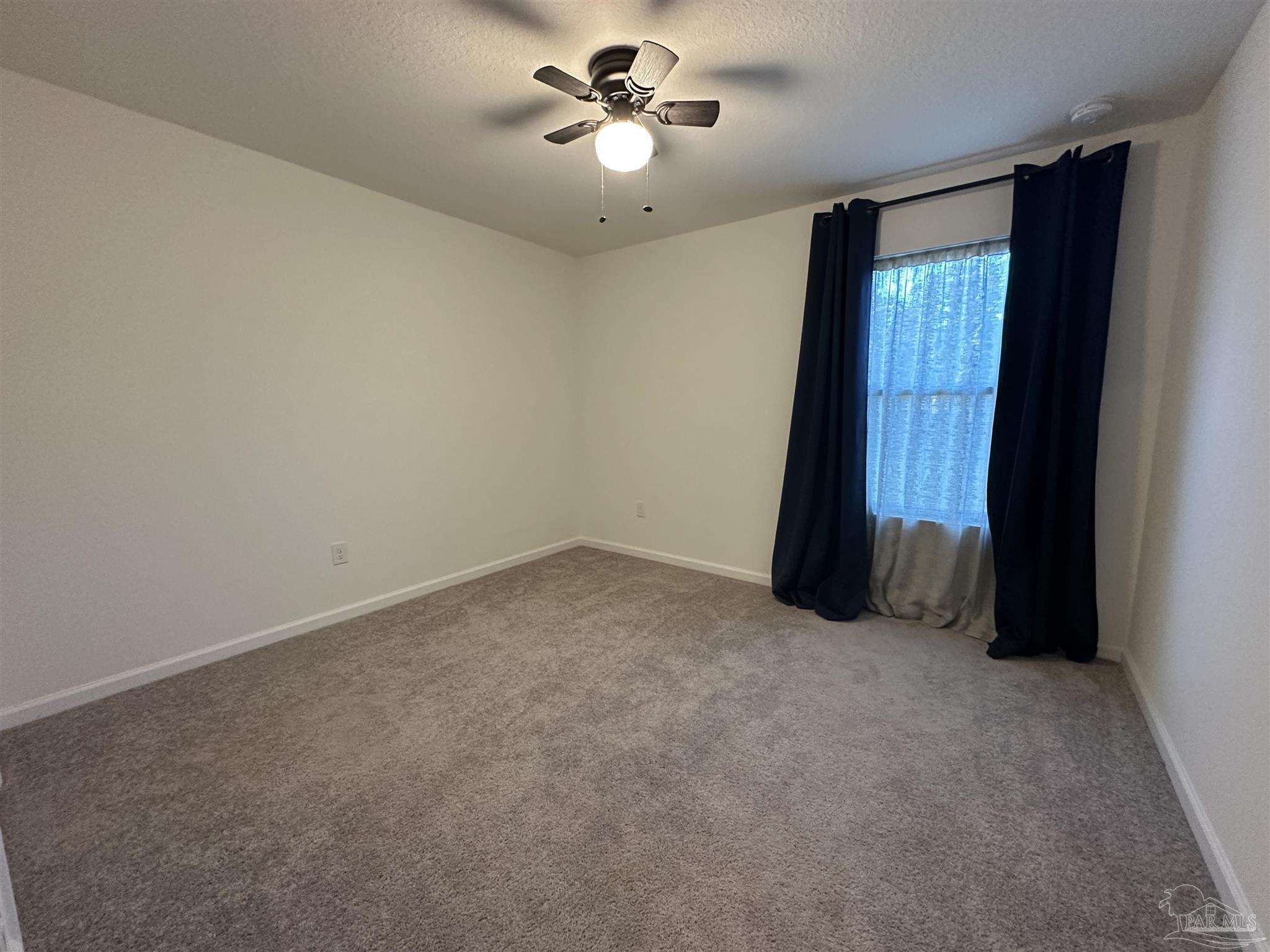 8752 Schooner Lane Pensacola, FL 32507 - Photo 11 of 13 an empty room with windows and fan
