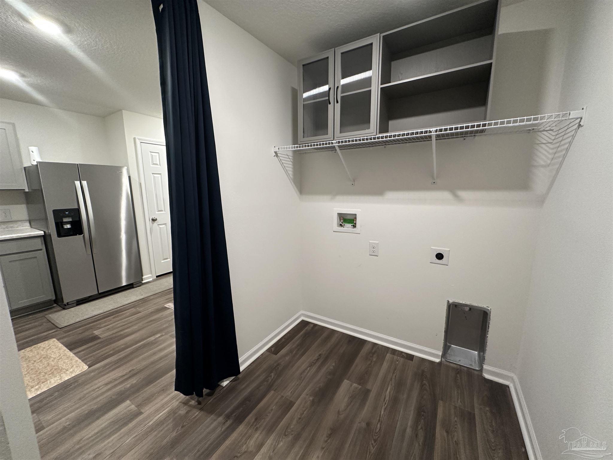 8752 Schooner Lane Pensacola, FL 32507 - Photo 12 of 13 a view of a hallway with wooden floor and a cabinet