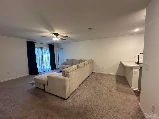 a living room with a bed furniture and dryer