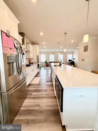a large white kitchen with stainless steel appliances