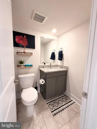 a bathroom with a toilet a sink and a mirror