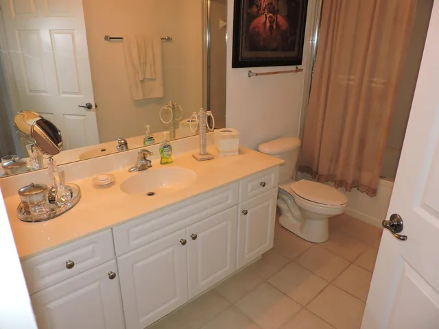 a bathroom with a double vanity sink and a mirror
