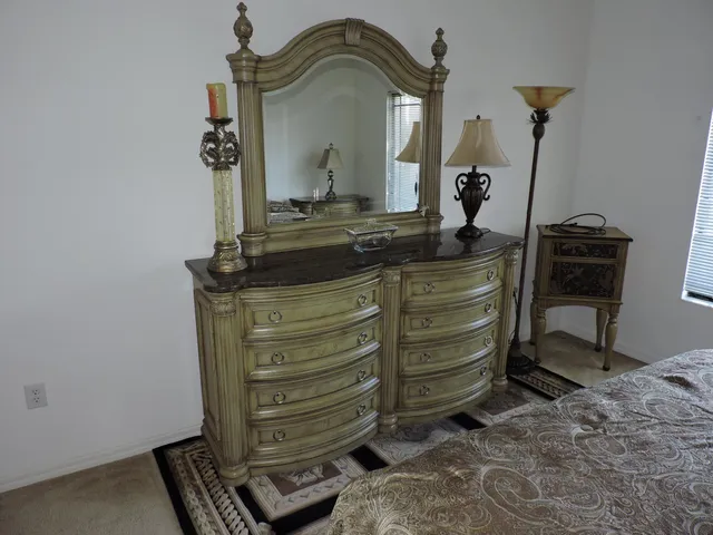 a view of living room with furniture and a mirror