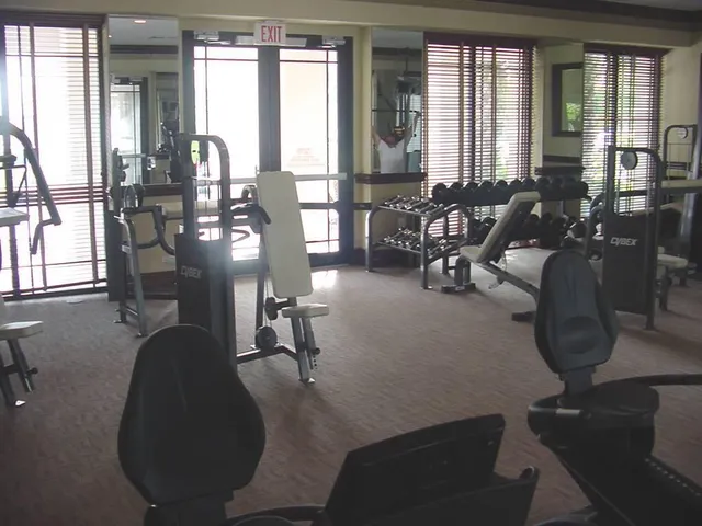 a living room with furniture and large windows