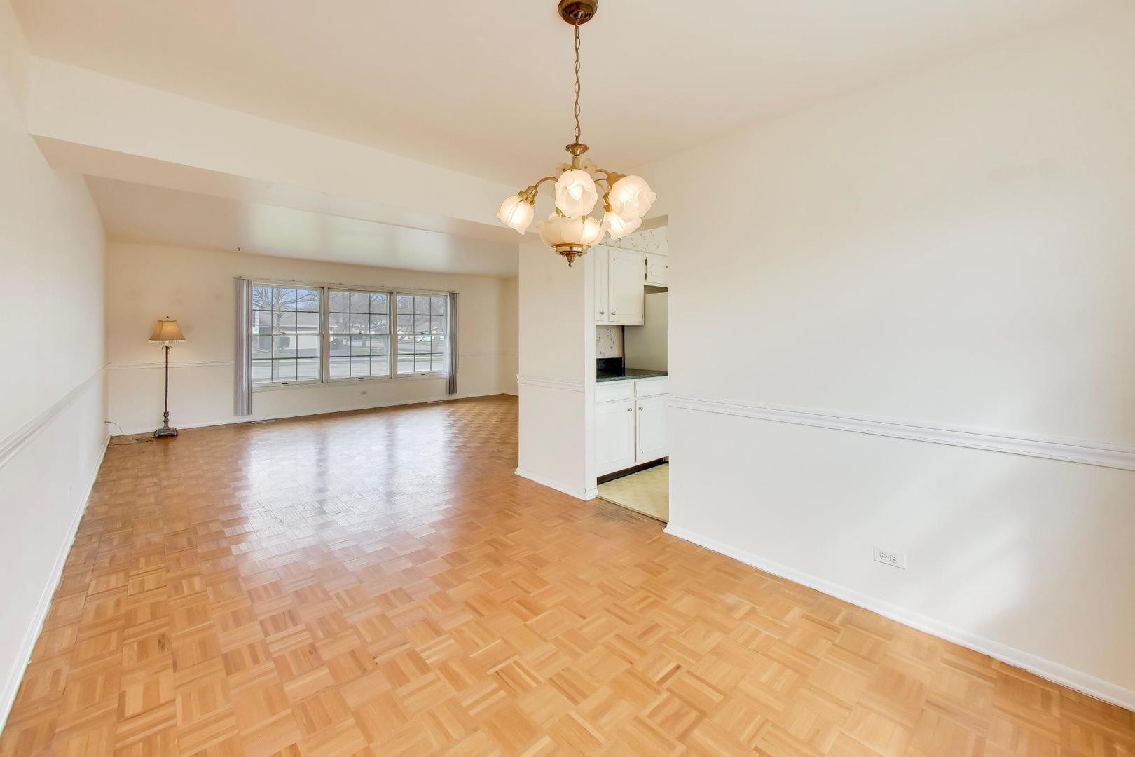 2703 North Ridge Avenue Arlington Heights, IL 60004 - Photo 12 of 51 a view of an empty room with wooden floor and a window