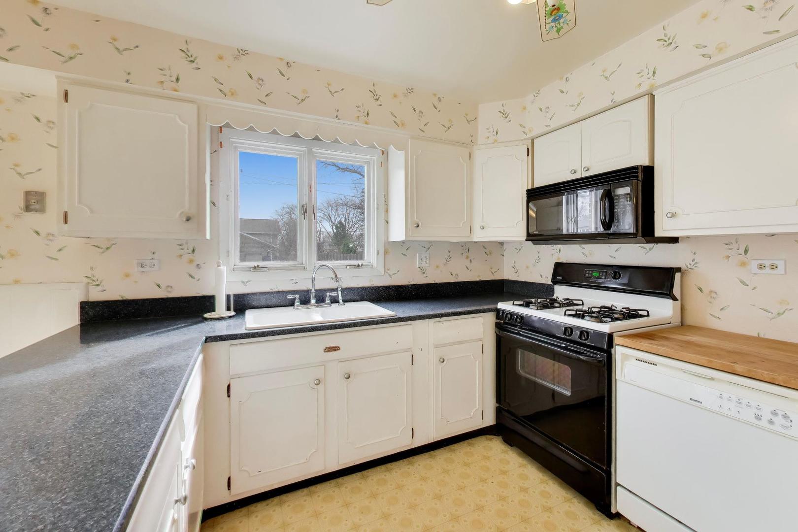 2703 North Ridge Avenue Arlington Heights, IL 60004 - Photo 13 of 51 a kitchen with granite countertop a sink stainless steel appliances and cabinets
