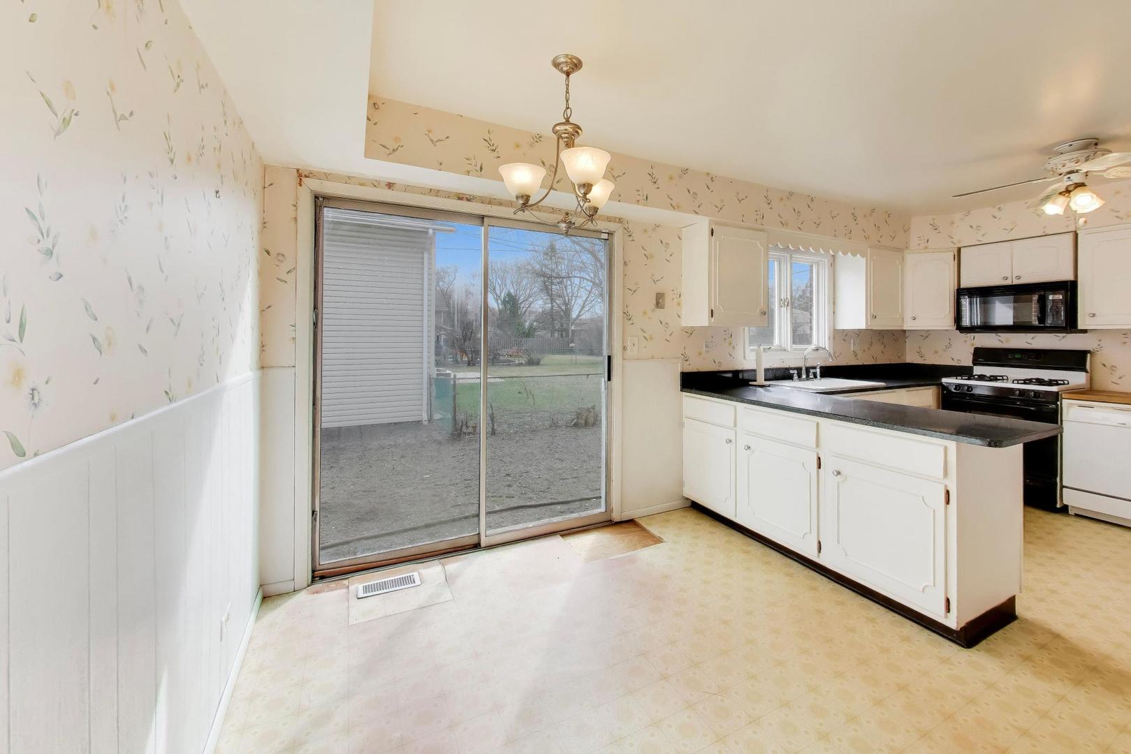 2703 North Ridge Avenue Arlington Heights, IL 60004 - Photo 17 of 51 a kitchen with stainless steel appliances granite countertop a stove a sink and a refrigerator
