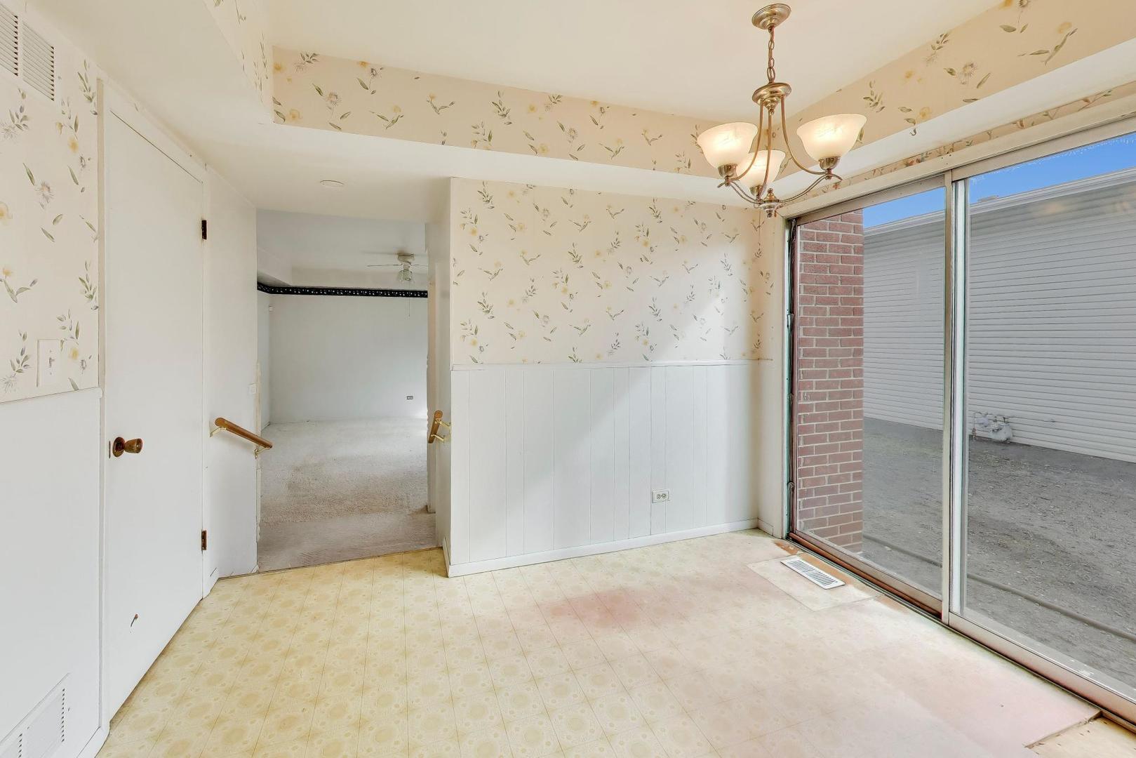 2703 North Ridge Avenue Arlington Heights, IL 60004 - Photo 18 of 51 a view of a big room with a chandelier fan and windows