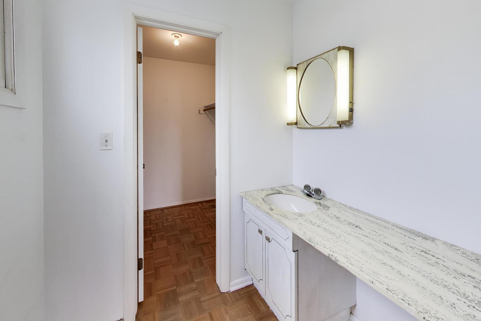 2703 North Ridge Avenue Arlington Heights, IL 60004 - Photo 26 of 51 a bathroom with a granite countertop sink and a mirror