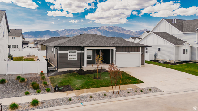 4595 North Fallow Way, Unit 511 Eagle Mountain, UT 84005 - Photo 32 of 32 View of front of house with board and batten siding, roof with shingles, and a mountain view