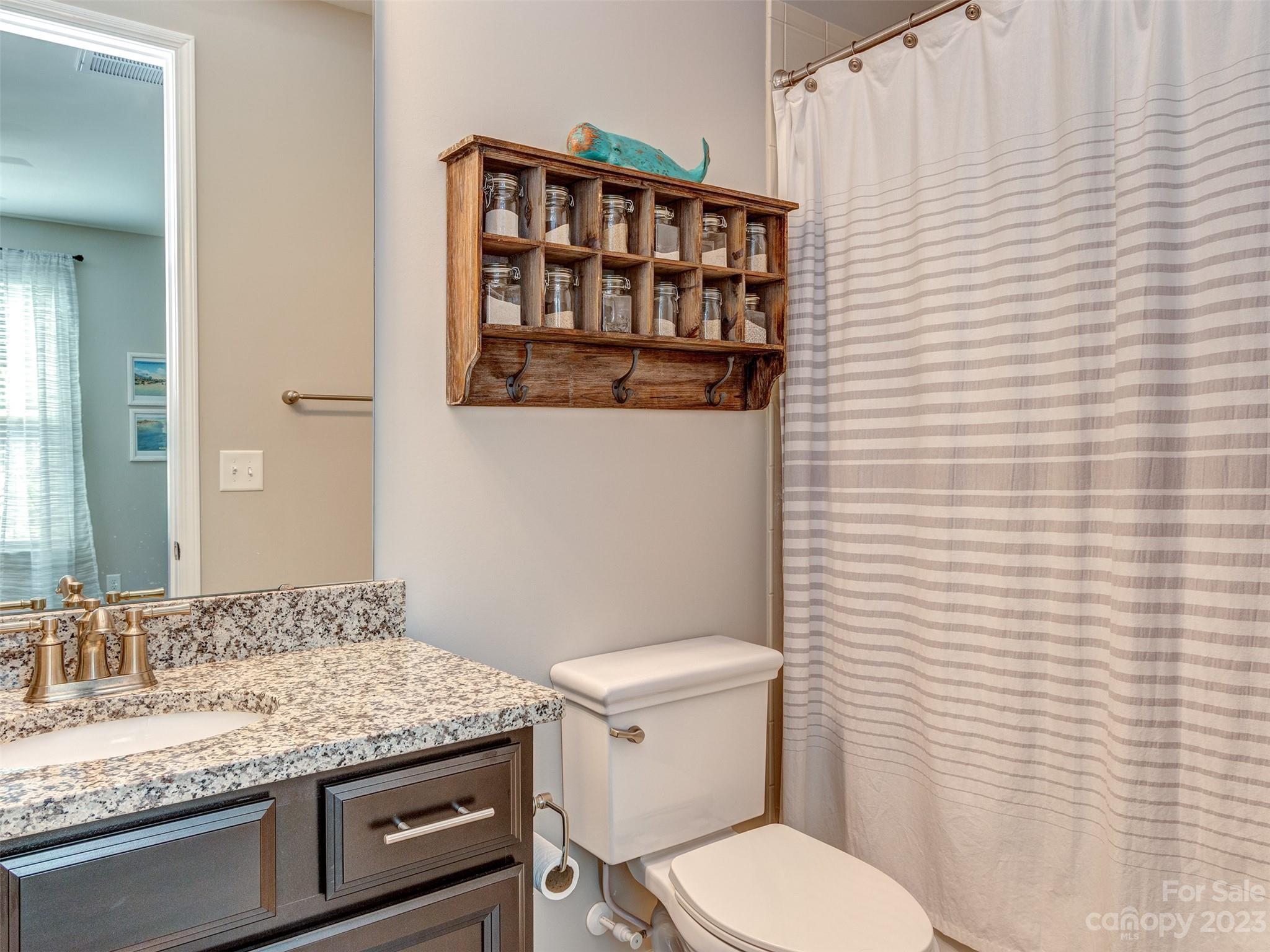 5515 Braddock Ml Way Lancaster, SC 29720 - Photo 16 of 41 a bathroom with a granite countertop toilet sink and mirror
