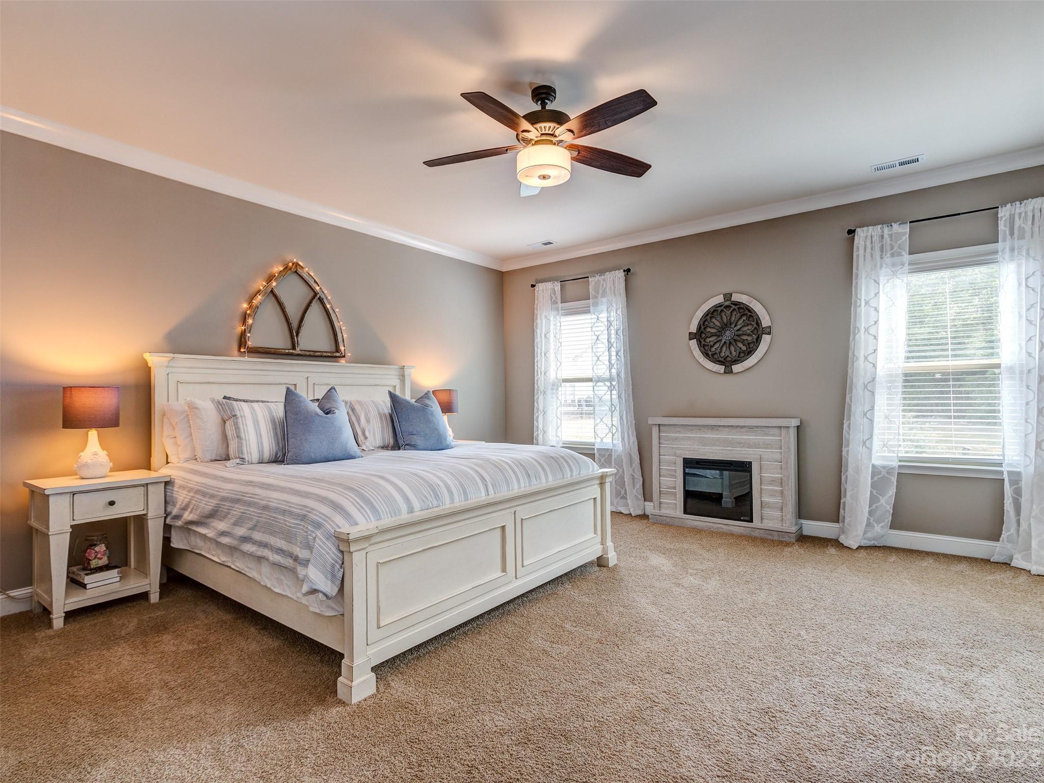 5515 Braddock Ml Way Lancaster, SC 29720 - Photo 19 of 41 a spacious bedroom with a bed and a ceiling fan