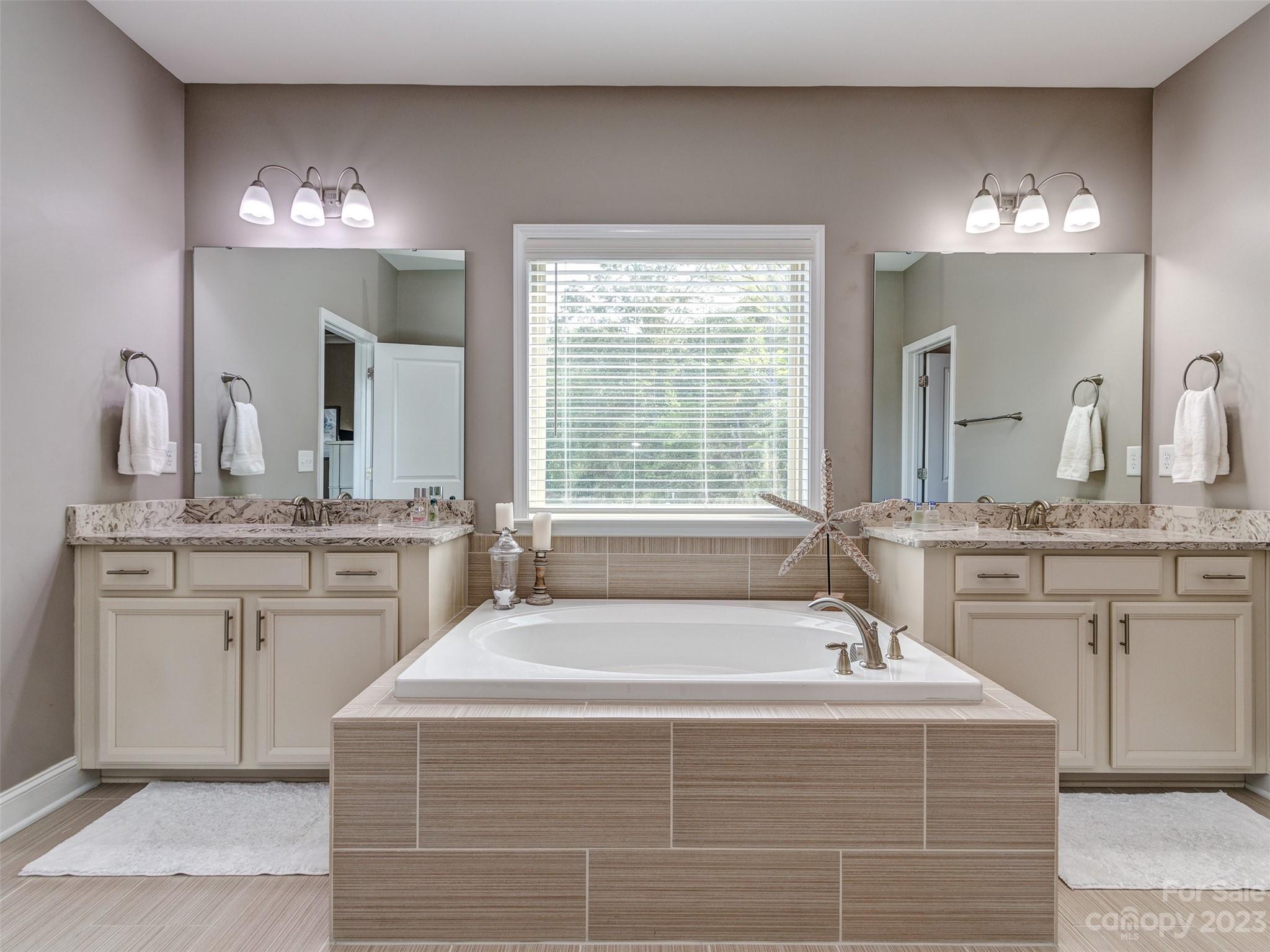 5515 Braddock Ml Way Lancaster, SC 29720 - Photo 20 of 41 a spacious bathroom with a granite countertop double vanity sink a mirror and a bathtub