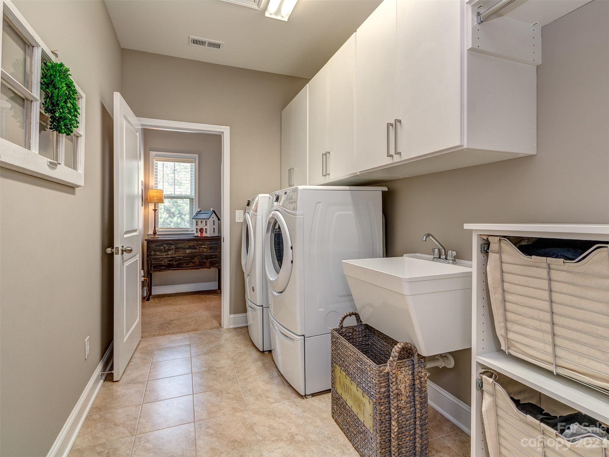 5515 Braddock Ml Way Lancaster, SC 29720 - Photo 24 of 41 a utility room with cabinets dryer and washer