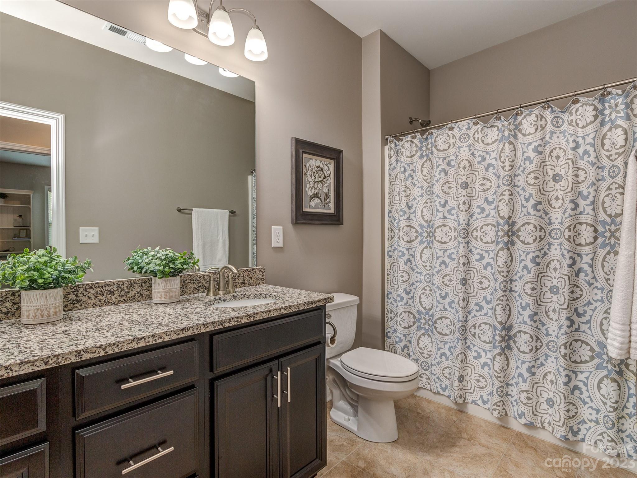 5515 Braddock Ml Way Lancaster, SC 29720 - Photo 28 of 41 a bathroom with a granite countertop sink a toilet and a mirror
